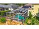 A screened pool with a connected jacuzzi and lush landscaping at 3620 Cordgrass Dr, Valrico, FL 33596