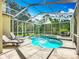 Inviting screened pool with lounge chairs, spa, and beautiful backyard perfect for unwinding at 3620 Cordgrass Dr, Valrico, FL 33596