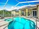 Gorgeous screened pool with lounge chairs and hot tub perfect for relaxing and entertaining guests at 3620 Cordgrass Dr, Valrico, FL 33596
