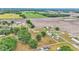 Extensive aerial image of a property with a home, several buildings, surrounded by mature trees and farmland at 3715 Fortner Rd, Plant City, FL 33567