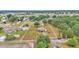 Vast aerial perspective showcasing a property with a home, structures, and a white surrounding fence at 3715 Fortner Rd, Plant City, FL 33567