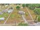 Expansive aerial view of a fenced property with well-maintained landscaping, mature trees and long drive at 3715 Fortner Rd, Plant City, FL 33567