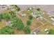 Full aerial showcasing a home, buildings, mature trees, and a white fence enclosing the entire property at 3715 Fortner Rd, Plant City, FL 33567