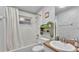 Bright bathroom featuring a tub with shower, vanity with sink, and decorative shelving at 3715 Fortner Rd, Plant City, FL 33567