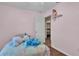 Cozy bedroom featuring closet space, soft bedding, and a pink wall color at 3715 Fortner Rd, Plant City, FL 33567