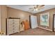 Bedroom features a dresser, ceiling fan, and natural light streaming through the window at 3715 Fortner Rd, Plant City, FL 33567
