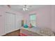 Cozy bedroom featuring closet space, a bright window, and colorful floral bedding at 3715 Fortner Rd, Plant City, FL 33567