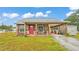 Quaint home featuring a long carport and lush lawn at 3715 Fortner Rd, Plant City, FL 33567