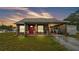 Charming home featuring a covered porch, red front door, and ample parking at 3715 Fortner Rd, Plant City, FL 33567