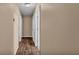 Clean hallway featuring hardwood floors, light paint, and doors leading to other rooms at 3715 Fortner Rd, Plant City, FL 33567