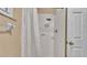 Shower with white tile and a shower curtain, providing a clean and functional space at 3715 Fortner Rd, Plant City, FL 33567