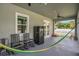 Relaxing back porch with rocking chairs, hammock, and ceiling fan at 5227 Lime Ave, Seffner, FL 33584