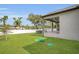 Spacious backyard with lush green lawn and covered porch at 5227 Lime Ave, Seffner, FL 33584