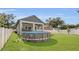 A spacious backyard features a pool, covered porch, and green lawn at 5227 Lime Ave, Seffner, FL 33584