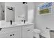 Bright bathroom featuring a double sink vanity with black hardware and modern fixtures, offering plenty of natural light at 5227 Lime Ave, Seffner, FL 33584