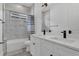 Modern bathroom with double vanity, marble countertops, and a tiled shower-tub combo at 5227 Lime Ave, Seffner, FL 33584