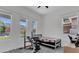 Well-lit bedroom featuring three large windows, fitness equipment, and ample space at 5227 Lime Ave, Seffner, FL 33584