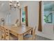 Dining room area featuring a wooden table with six chairs and natural light from the windows at 5227 Lime Ave, Seffner, FL 33584