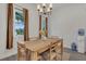 Bright dining room features a modern chandelier, neutral decor, and a wooden table set at 5227 Lime Ave, Seffner, FL 33584