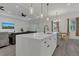 Open concept kitchen with a large island, pendant lights, and flows into the living area at 5227 Lime Ave, Seffner, FL 33584