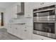 Modern kitchen equipped with stainless steel appliances, white cabinets, and stylish backsplash at 5227 Lime Ave, Seffner, FL 33584