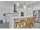 Modern kitchen featuring a large island, stainless steel appliances, and sleek white cabinets at 5227 Lime Ave, Seffner, FL 33584