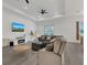 Bright living room showcasing a gray sectional, TV, and neutral decor at 5227 Lime Ave, Seffner, FL 33584