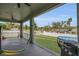 Spacious covered patio with a hammock, grill, and views of a backyard with a pool, ideal for outdoor living at 5227 Lime Ave, Seffner, FL 33584