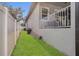 A side yard with grass is between the fence and home at 5227 Lime Ave, Seffner, FL 33584