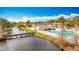 Waterfront view of community pool and deck with a wooden bridge, set in a lush, landscaped area at 6350 92Nd N Pl # 2206, Pinellas Park, FL 33782
