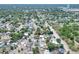 Expansive aerial view of a neighborhood featuring lush greenery, houses, and streets at 10804 N Leo St, Tampa, FL 33612
