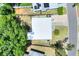 Aerial view of a home with a white roof, surrounded by trees and adjacent properties at 10804 N Leo St, Tampa, FL 33612