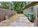 Backyard enclosed by a wood fence, showing minimal landscaping at 10804 N Leo St, Tampa, FL 33612
