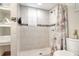 Bathroom shower tiled with built in shelves and mosaic tile accent at 10804 N Leo St, Tampa, FL 33612