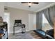 Bedroom with a futon, desk, laminate floors and a view from the large window at 10804 N Leo St, Tampa, FL 33612
