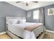 Bedroom with upholstered bed frame, soft rug, and a ceiling fan at 10804 N Leo St, Tampa, FL 33612