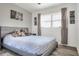 Bright bedroom with laminate flooring, large window, grey bed frame, and stuffed animals at 10804 N Leo St, Tampa, FL 33612