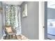 Bedroom sitting area with chair and ivy wall hanging at 10804 N Leo St, Tampa, FL 33612