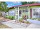 Quaint front porch featuring stylish bars, a seating area, and inviting landscaping at 10804 N Leo St, Tampa, FL 33612