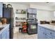 Kitchen area includes open shelving, black appliances, and a view into the dining room at 10804 N Leo St, Tampa, FL 33612