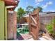 Charming outdoor seating area with a wooden fence, table, chairs, and artificial turf at 10804 N Leo St, Tampa, FL 33612