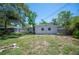 Lawn of the backyard with a mix of grass and sand. The house is white with two small windows at 6011 67Th N Ave, Pinellas Park, FL 33781