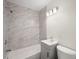 Bathroom featuring sleek white tiled shower, gray vanity, and updated fixtures at 6011 67Th N Ave, Pinellas Park, FL 33781