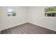 Cozy bedroom featuring gray floors, white walls, and two windows at 6011 67Th N Ave, Pinellas Park, FL 33781