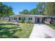 Charming single-story home with a well-manicured lawn and a convenient carport at 6011 67Th N Ave, Pinellas Park, FL 33781