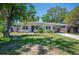 Inviting single-story home with a covered carport and neatly landscaped front yard at 6011 67Th N Ave, Pinellas Park, FL 33781