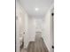 A bright hallway showcasing hard surface floors and access to a bathroom at 6011 67Th N Ave, Pinellas Park, FL 33781