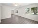 Open living area features gray wood-look flooring, and plenty of natural light at 6011 67Th N Ave, Pinellas Park, FL 33781