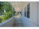 Inviting porch with white columns and lush landscaping at 6011 67Th N Ave, Pinellas Park, FL 33781