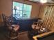 Charming bar area with barstools and a window providing natural light at 9912 Pine Leaf Ln, Dade City, FL 33525